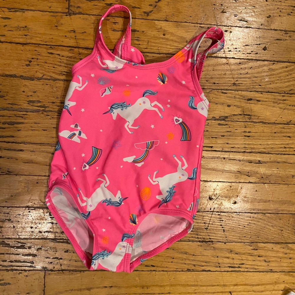 Oshkosh one piece unicorn and rainbow bathing suit in fluorescent pink.